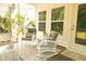 Relaxing sunroom with wicker rocking chairs, neutral cushions, and views of the backyard at 1030 Grace Field Ave, Summerville, SC 29485