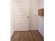 Neat walk-in closet with wooden floors, white door, and wire shelving with a basket for organization at 1030 Grace Field Ave, Summerville, SC 29485