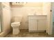 Bathroom featuring tile flooring, a white toilet, and white cabinetry at 1044 Academy Rd, Walterboro, SC 29488