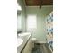 Bathroom with modern flooring, white fixtures, and a colorful shower curtain at 1044 Academy Rd, Walterboro, SC 29488