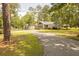 Charming single-story home boasts a well-manicured lawn, mature trees, and a private driveway at 1044 Academy Rd, Walterboro, SC 29488