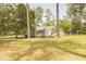 Exterior view of the rear of a house and garage on large lot with picnic table at 1044 Academy Rd, Walterboro, SC 29488