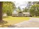 Charming home with a green lawn, a paved driveway, and a detached garage at 1044 Academy Rd, Walterboro, SC 29488