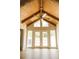 Bright living room features vaulted wood ceilings, an elegant ceiling fan, and French doors at 1044 Academy Rd, Walterboro, SC 29488