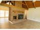 Cozy living room showcasing a brick fireplace, vaulted ceilings, and wood-look floors at 1044 Academy Rd, Walterboro, SC 29488