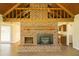 Living room with a brick fireplace extending to the vaulted ceiling, complemented by wood-look floors at 1044 Academy Rd, Walterboro, SC 29488