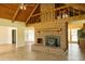 Open-concept living room featuring a brick fireplace, vaulted ceiling, and wood-look floors at 1044 Academy Rd, Walterboro, SC 29488