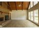 Spacious living room with a brick fireplace, vaulted ceilings, and ample natural light from large windows at 1044 Academy Rd, Walterboro, SC 29488