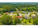 Overhead view of homes in a leafy neighborhood, showcasing the house with generous tree cover and nearby lake access at 107 Salina Ln, Goose Creek, SC 29445