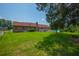 Spacious backyard with a well-maintained lawn, mature trees, and the rear view of a brick home, ideal for outdoor activities at 107 Salina Ln, Goose Creek, SC 29445