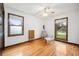 Bright and airy bedroom featuring hardwood floors, two windows, and ceiling fan at 107 Salina Ln, Goose Creek, SC 29445