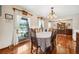 Bright dining room with hardwood floors, a chandelier, and large windows offering a view at 107 Salina Ln, Goose Creek, SC 29445