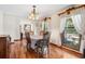 Elegant dining room with hardwood floors, a chandelier, and large windows with white curtains at 107 Salina Ln, Goose Creek, SC 29445