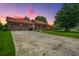 Brick home with a two-car garage, mature trees, and a ramp for accessibility, showcasing the property's curb appeal at 107 Salina Ln, Goose Creek, SC 29445