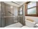 Updated shower featuring glass doors, a handheld shower head, and a tiled surround at 107 Salina Ln, Goose Creek, SC 29445