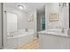 Bright bathroom with a jetted tub and white marble countertop at 111 Long Bow Rd, Summerville, SC 29485
