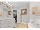 Bright bathroom featuring a double vanity, soaking tub and access to the primary bedroom at 111 Long Bow Rd, Summerville, SC 29485