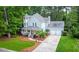 Aerial view of the home with charming front porch, two-car garage and manicured lawn at 111 Long Bow Rd, Summerville, SC 29485
