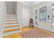 Bright foyer features hardwood floors, decorative rug, and staircase adding warmth and character at 111 Long Bow Rd, Summerville, SC 29485