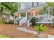 Inviting front porch with brick accents, white railing, and lush landscaping creates curb appeal at 111 Long Bow Rd, Summerville, SC 29485