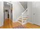 Bright hallway showcases hardwood floors and a staircase, creating a sense of flow and connectivity at 111 Long Bow Rd, Summerville, SC 29485