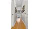 Hallway with hardwood floors leading to a bright foyer with a decorative front door at 111 Long Bow Rd, Summerville, SC 29485