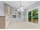 Eat-in kitchen features light-colored cabinetry, tile floors and access to the backyard at 111 Long Bow Rd, Summerville, SC 29485