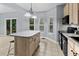 Bright kitchen features an island with a granite countertop, offering a delightful cooking and gathering space at 111 Long Bow Rd, Summerville, SC 29485