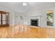 Bright living room features hardwood floors, fireplace, and abundant natural light from large windows at 111 Long Bow Rd, Summerville, SC 29485