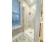 Shower featuring marble tiling, glass door and built-in shelf, with natural lighting at 111 Long Bow Rd, Summerville, SC 29485