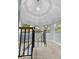 Top of a spiral staircase with natural light shining through windows at 111 Long Bow Rd, Summerville, SC 29485