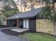 Charming single-story home featuring dark siding, a modern fence, and beautiful landscaping at 1119 Morning Glory Ct, Mount Pleasant, SC 29464