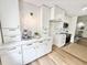 Bright, modern kitchen with white cabinets, stainless steel appliances, and wood floors at 1119 Morning Glory Ct, Mount Pleasant, SC 29464