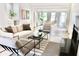 Bright, open-concept living room features modern furniture, light wood floors, and lots of natural light at 1119 Morning Glory Ct, Mount Pleasant, SC 29464