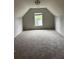 Finished attic featuring plush carpeting, a modern light fixture and a window offering natural light at 113 Lebsl Ct, Summerville, SC 29483