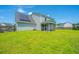 Well-maintained backyard features a screen porch, green lawn, solar panels, and a wooden fence at 113 Lebsl Ct, Summerville, SC 29483