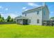 Large backyard with a screen porch, green lawn, solar panels, and wooden privacy fence at 113 Lebsl Ct, Summerville, SC 29483
