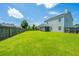 Home exterior featuring a lush, green backyard and tall fence at 113 Lebsl Ct, Summerville, SC 29483