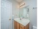 Well-lit bathroom with a wood vanity and cream colored countertop, door and mirror at 113 Lebsl Ct, Summerville, SC 29483