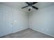 Carpeted bedroom with ceiling fan, door, and neutral color scheme at 113 Lebsl Ct, Summerville, SC 29483