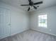 Light and airy carpeted bedroom with ceiling fan and window overlooking the yard at 113 Lebsl Ct, Summerville, SC 29483