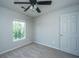 Well-lit bedroom with ceiling fan and window overlooking the yard at 113 Lebsl Ct, Summerville, SC 29483