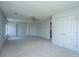 A carpeted bedroom with a ceiling fan and double door closet at 113 Lebsl Ct, Summerville, SC 29483