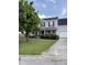 Charming two-story home featuring a well-manicured lawn, mature landscaping, and a welcoming front porch at 113 Lebsl Ct, Summerville, SC 29483