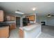 The eat-in kitchen features wood cabinets, black appliances, and an island opening up to the living room with fireplace at 113 Lebsl Ct, Summerville, SC 29483