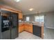This kitchen features a double sink, black appliances and a view of the yard from the window at 113 Lebsl Ct, Summerville, SC 29483