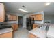 This kitchen has wood cabinets and black appliances with easy access to the backyard and adjacent living room at 113 Lebsl Ct, Summerville, SC 29483