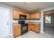 A well-designed kitchen boasts ample cabinet space, black appliances, and modern finishes for efficient cooking at 113 Lebsl Ct, Summerville, SC 29483