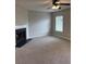 Inviting living room featuring a cozy fireplace, plush carpet, and a large window for natural light at 113 Lebsl Ct, Summerville, SC 29483