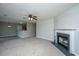 Open-concept living room features fireplace and breakfast bar with updated carpet at 113 Lebsl Ct, Summerville, SC 29483